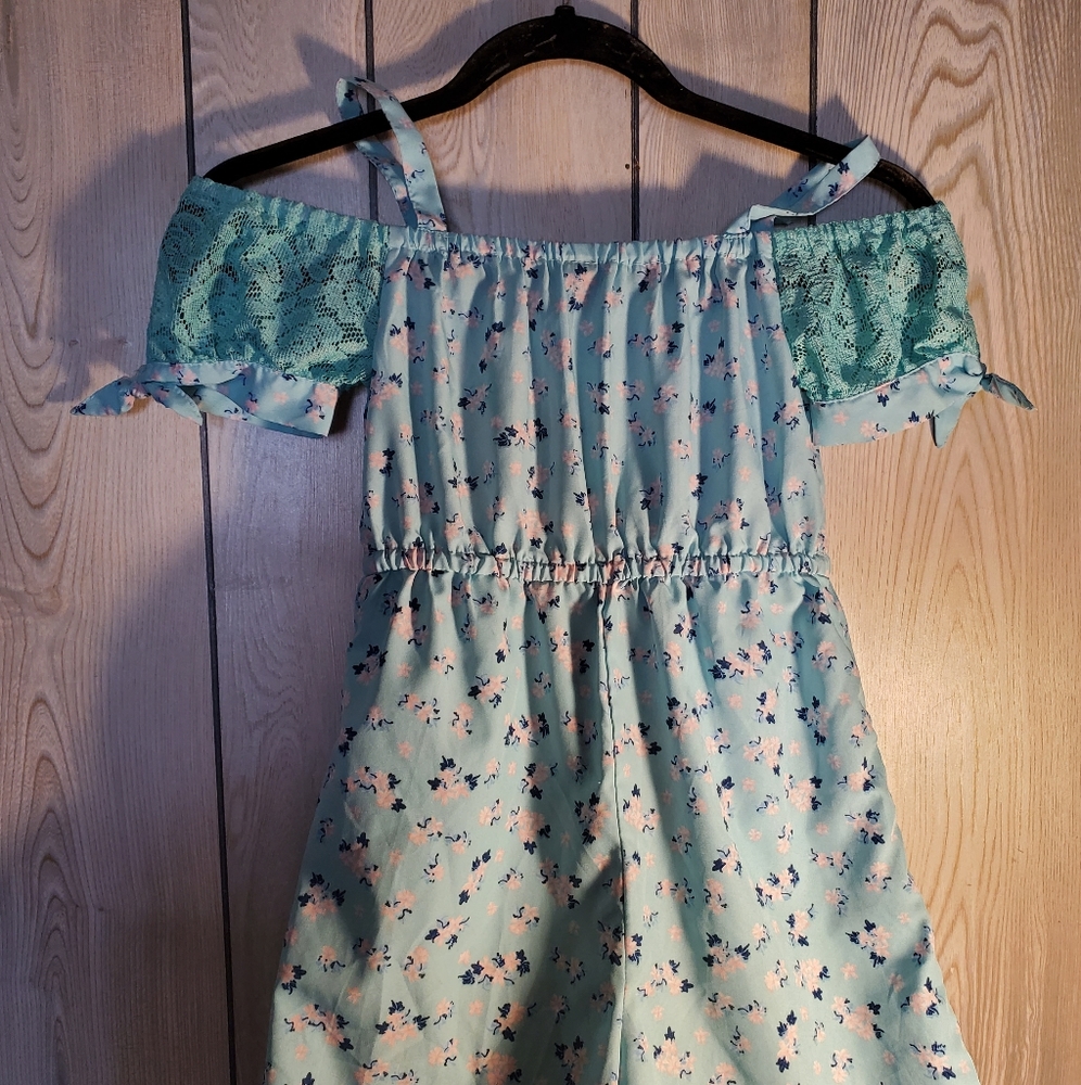 Little girls teal with flowers gently  worn